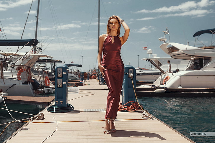 women's red dress, Anton Artyushin, women, model, brunette, looking at viewer, dress, dock, yachts, water, sky, women outdoors, HD wallpaper