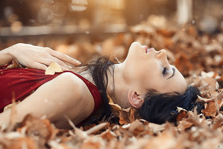 women's red tank top, woman in maroon sleeveless dress laying down on a bunch of brown leaves, women, brunette, black hair, red dress, leaves, fall, closed eyes, Alessandro Di Cicco, HD wallpaper