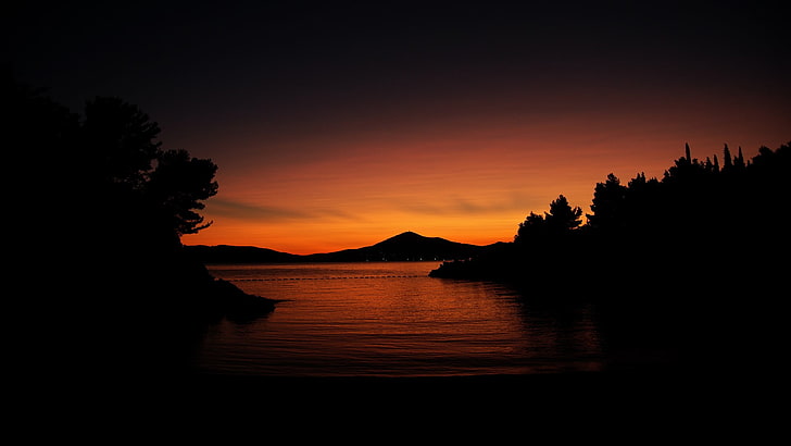 silhouette of mountain, sunset, nature, trees, water, calm, dark, orange, hills, sunlight, HD wallpaper