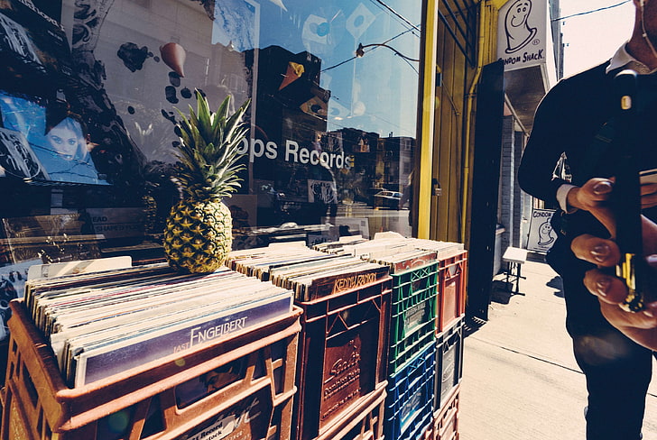 business, commerce, crate, downtown, fruit, hands, iphone, man, mobile phone, people, pineapple, records, reflections, shop window, smartphone, store, street, taking photo, tropical fruit, urban, wear, woman, HD wallpaper