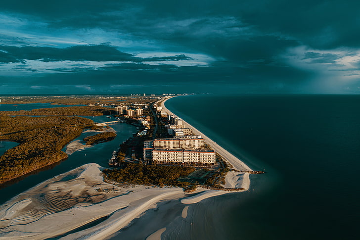 aerial photography of buildings near coastline, USA, shore, coast, sand, sunlight, clouds, trees, cityscape, sea, water, building, HD wallpaper