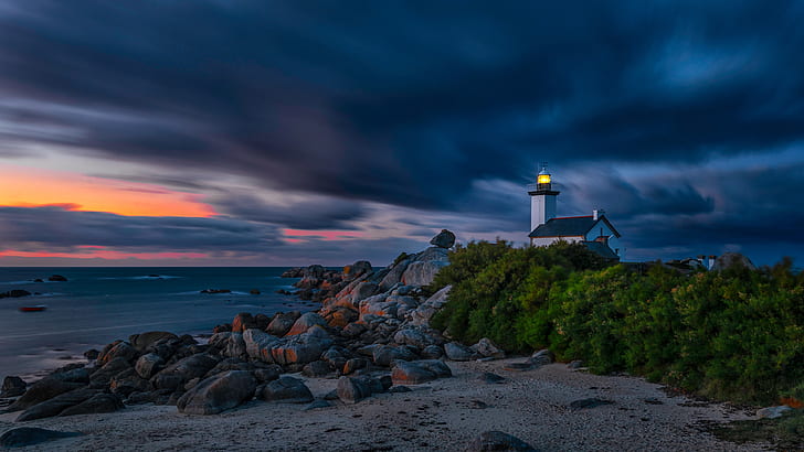 sand, sea, light, night, clouds, lights, stones, the wind, shore, lighthouse, the atmosphere, house, twilight, the bushes, boulders, burning, gloomy sky, HD wallpaper