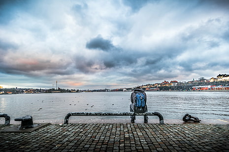 person in gray jacket and blue backpack sitting on black steel tube bench beside body of water under white clouds, sunset, person, gray, jacket, blue, backpack, black steel, tube, bench, body of water, white clouds, alone, candid, city, europe, konica minolta, landscape, man, photo, photography, sea, seascape, sky, sony a7, stockholm, sweden, travel, urban, view, weather, faceless, street photography, people, urban Scene, outdoors, HD wallpaper HD wallpaper