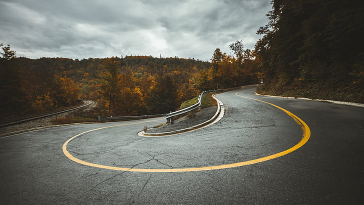 winding road, shallow focus photography of a concrete road, road, hairpin turns, railroad track, forest, guardrail, trees, fall, HD wallpaper