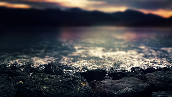 rochas negras, foto closeup de rochas perto do corpo de água ao entardecer, mar, montanhas, profundidade de campo, rocha, costa, pedras, água, natureza, HD papel de parede HD wallpaper
