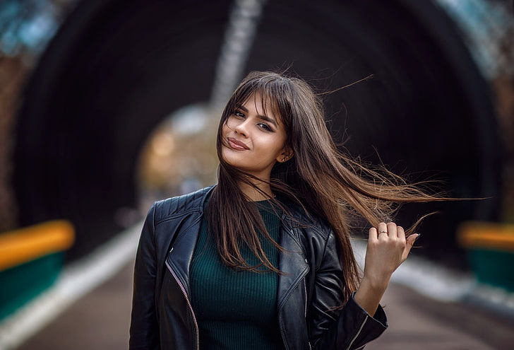 women outdoors, women, long hair, leather jackets, touching hair, holding hair, black jackets, windy, brunette, brown eyes, sweater, Public, looking at viewer, HD wallpaper