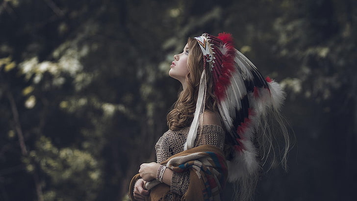 women's gray native American costume, woman in white, red, and black feather headdress looking up, brunette, nature, headdress, profile, women, model, long hair, women outdoors, looking up, open mouth, feathers, Native American clothing, sweater, trees, depth of field, cardigan, Pauly Pholwises, Abbie, HD wallpaper