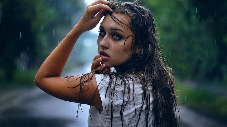 women's white tee shirt, focus photo of woman in white cap-sleeved shirt, women, model, brunette, long hair, women outdoors, trees, open mouth, blue eyes, wet hair, wet, water drops, rain, hands on head, looking back, looking at viewer, wet clothing, finger on lips, HD wallpaper