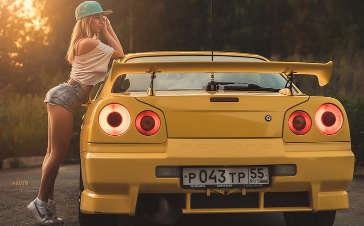 yellow vehicle, Nissan Skyline, car, vehicle, women, ass, jean shorts, legs, women with cars, model, HD wallpaper