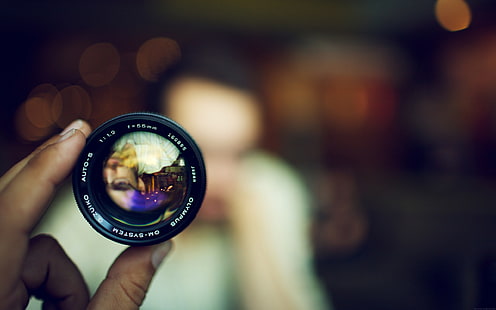 black camera lens, person holding camera lens, bokeh, lens, face, blurred, technology, hands, Olympus, HD wallpaper HD wallpaper