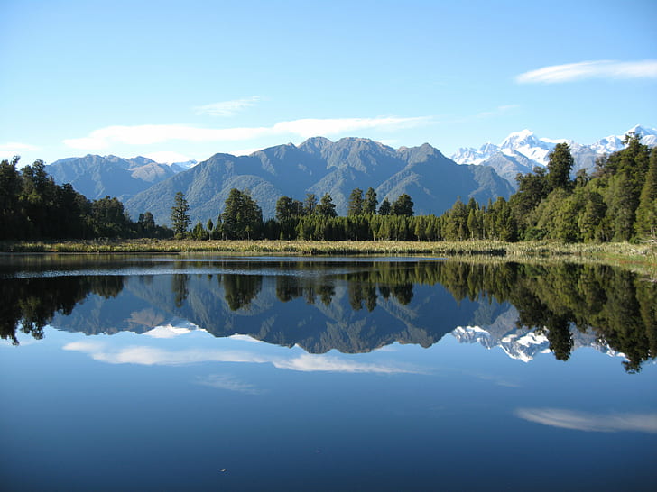 landscape photo of lake near green trees under blue sky during daytime, mirror lake, mirror lake, Mirror Lake, New Zealand, landscape, photo, green, trees, blue sky, daytime, Lake Matheson, lake  matheson, mirror  reflection, mountains, calm, serene, water, nature, lake, mountain, reflection, scenics, outdoors, mountain Range, forest, sky, summer, tree, mountain Peak, beauty In Nature, HD wallpaper