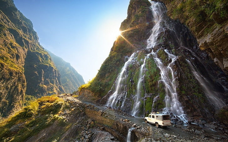 waterfalls and rock formations, nature, landscape, mountains, waterfall, sun rays, dirt road, vehicle, sunlight, moss, shrubs, Nepal, HD wallpaper