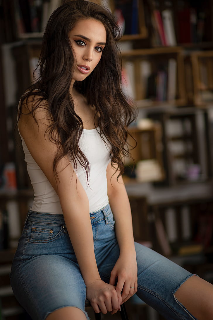Anna Bous, women, brunette, long hair, model, brown eyes, looking at viewer, eyeliner, portrait display, vertical, white tops, jeans, torn jeans, ripped clothes, sitting, depth of field, indoors, women indoors, Chris Bos, HD wallpaper