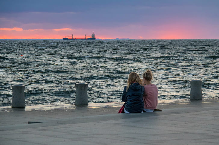 two woman sitting on brown ground near body of water during golden time, Sunset, two woman, brown, ground, body of water, golden time, Malmö  Västra, Västra Hamnen, cloud, hav, kvinna, people, sea, sky, woman, exif, model, canon eos, 760d, geo, country, focal_length, mm, camera, city, state, geo:location, lens, ef, s18, f/3.5, iso_speed, aperture, ƒ / 5, canon, women, outdoors, HD wallpaper