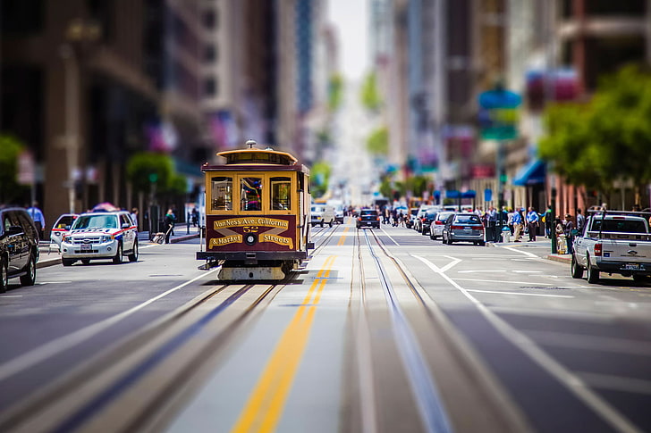 yellow and maroon tram, yellow tram traveling on road focus photography, street, car, road, city, tilt shift, cityscape, San Francisco, tram, blurred, building, HD wallpaper