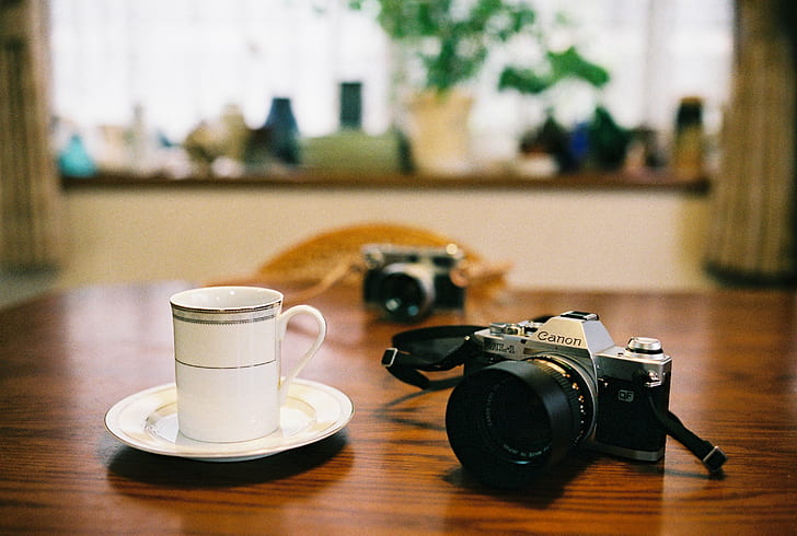 black DSLR camera with white ceramic cup, DSLR camera, white, ceramic, cup, 35mm, Canon AL-1, FD, F1.4, S.S.C., gear, Sigma SA, 7n, japan, fujifilm, film, Fujicolor, Natura, fuji, SA-7, Art, camera - Photographic Equipment, retro Styled, old-fashioned, table, HD wallpaper