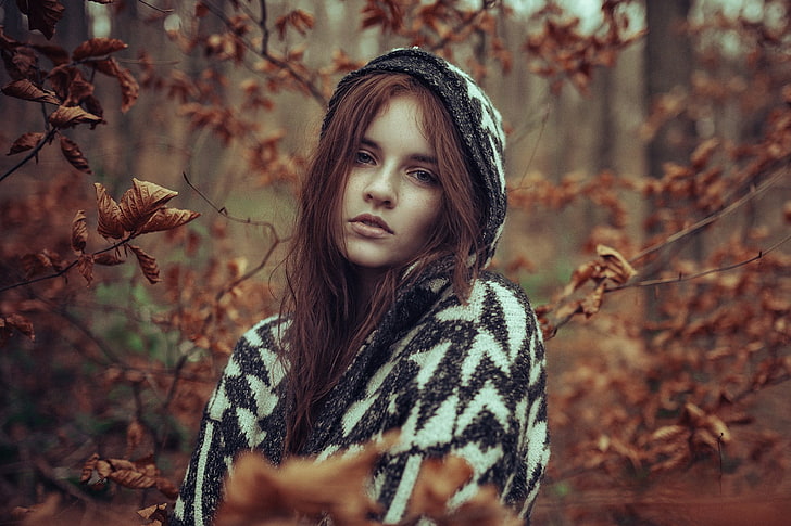 women's white and black hoodie, selective focus photography of woman wearing black and white chevron knitted hoodie at woods, women, model, redhead, long hair, women outdoors, looking at viewer, nature, trees, forest, sweater, leaves, branch, fall, hoods, open mouth, freckles, depth of field, HD wallpaper