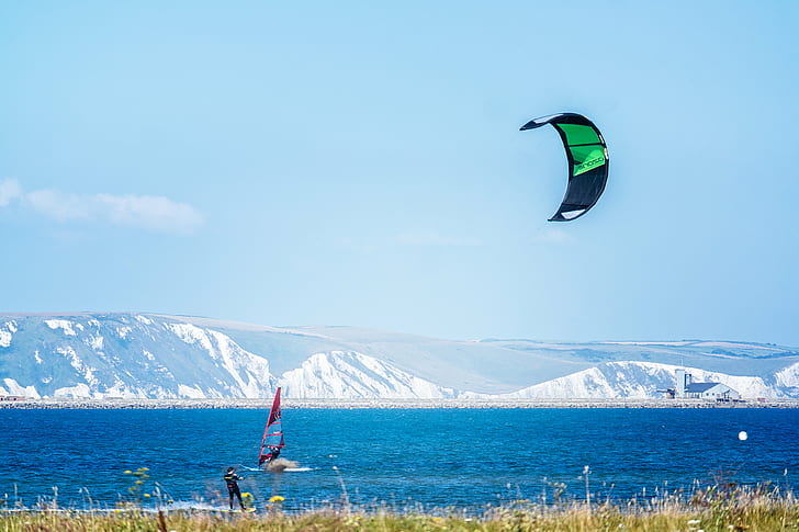 person riding water skis holding parachute near person windsurfing near the glacier mountains, Windsurfing, Portland Harbour, person, water skis, parachute, glacier, mountains, Chesil Beach, Dorset, Lightroom, London, Photo, Samsung, Weymouth, sea, windsurfer, Creative Commons, sport, outdoors, extreme Sports, action, nature, mountain, people, blue, men, HD wallpaper