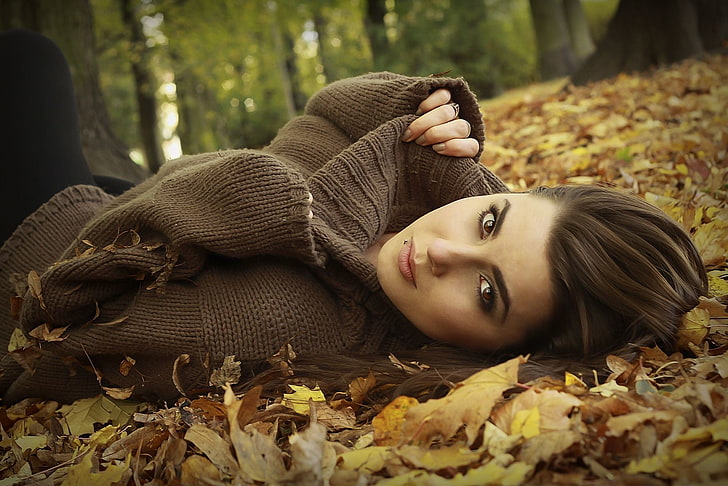 women's brown turtleneck sweater, woman laying of leaves, model, brunette, long hair, women outdoors, nature, trees, leaves, sweater, piercing, fall, brown eyes, pierced lip, Sandra, face, looking at viewer, HD wallpaper