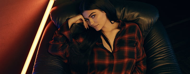 woman wearing black and red checkered dress shirt lying on black leather sofa chair inside well-lit room, Kylie Jenner, HD, HD wallpaper