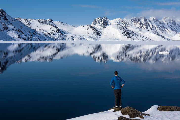 landscape photo of man wearing blue hoodie jacket and black pants standing beside body of water during daytime, pause, reflection, landscape, photo, man, blue, hoodie, jacket, black, pants, body of water, daytime, Grönland, Kulusuk, Sermersooq, GL, Canon  EOS  5D, winter, cold, ice  mountain, sea, Greenland, Fjord, snow, silence, beautiful, mountain, outdoors, nature, men, people, sport, HD wallpaper