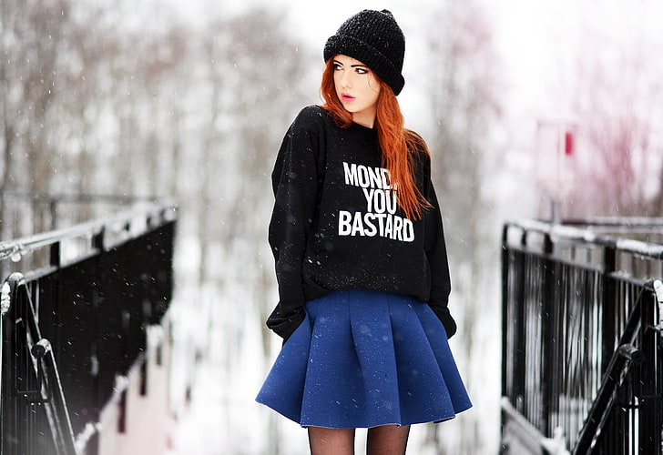 women's black pullover hoodie and blue pleated skirt, woman in black long-sleeved shirt and blue pleated miniskirt standing, women, model, Ebba Zingmark, redhead, long hair, women outdoors, open mouth, hat, snow, winter, black stockings, knit hat, millinery, blue skirt, looking away, hands in pockets, blouse, Wool cap, blouses, HD wallpaper