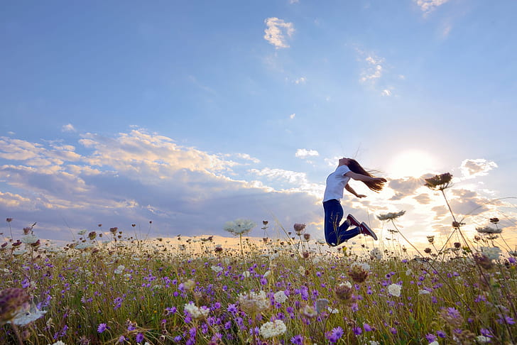 field, summer, the sky, girl, the sun, clouds, light, joy, happiness, flowers, pose, emotions, mood, jump, jeans, positive, meadow, long hair, the time, in the air, jumping, against the sky, jumped, HD wallpaper