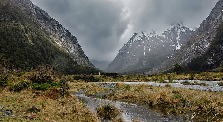 landscape photo of mountain valley during cloudy day, Stormy, landscape, photo, mountain, cloudy, day, Milford Sound, Valley, Storm, River, Bridge, Nikon  D5100, Tokina, 16mm, Clouds, New Zealand  South  Island, nature, outdoors, scenics, mountain Peak, HD wallpaper