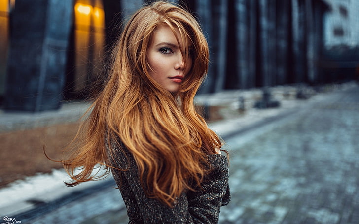 women's gray top, shallow focus photography of a woman in gray trench coat, face, blurred, women, redhead, model, long hair, women outdoors, looking at viewer, street, building, windy, coats, depth of field, Georgy Chernyadyev, Antonina Bragina, HD wallpaper