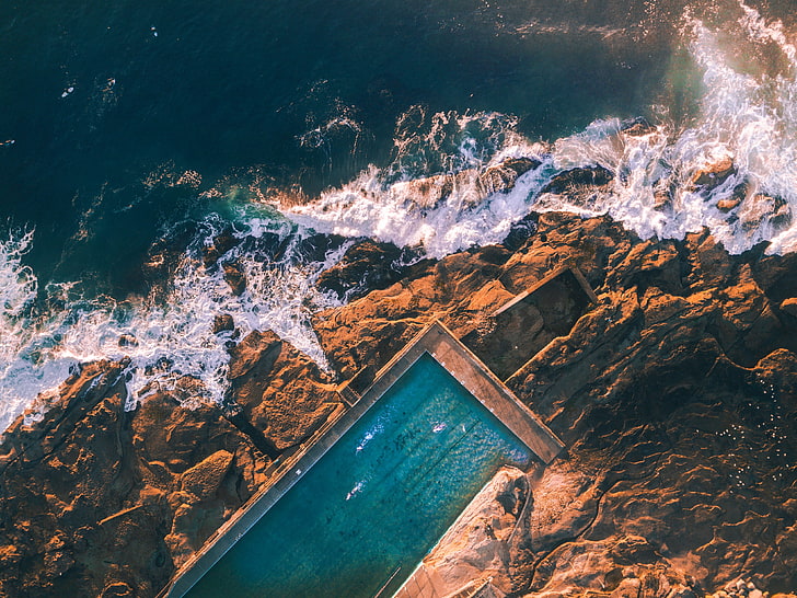 brown cliff, aerial view photography of swimming pool near sea at daytime, nature, water, rock, aerial view, landscape, sea, swimming pool, HD wallpaper