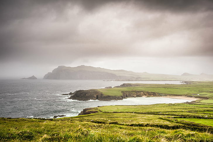 green grass land beside body of water, ireland, ireland, Dingle peninsula, Ireland, green grass, grass land, body of water, beach, clouds, dark, europe, fog, geotagged, landscape, photo, photography, sea, sel2870, sky, sony a7, travel, weather, Kerry, day, nature, scenics, coastline, cloud - Sky, mountain, outdoors, atlantic Ocean, HD wallpaper