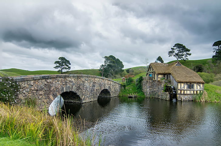 photography of brown house near body of water surrounded by trees under gray sky, Hobbiton, mill, double, arched bridge, photography, brown house, body of water, trees, LOTR, Hobbit, New Zealand, Nikon  D5100, HDR, Tokina, 16mm, nature, cultures, river, architecture, history, water, HD wallpaper