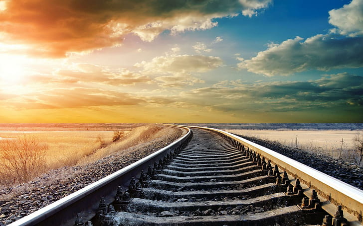 Train Tracks To The Setting Sun, rail road, tracks, gravel, train, fields, clouds, sunset, nature and landscapes, HD wallpaper