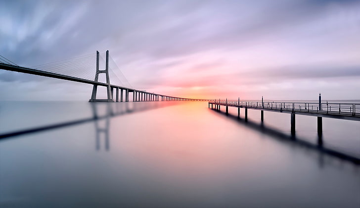 gray bridge, silhouette of bridge over calm body of water, bridge, water, landscape, pier, shadow, sunset, sea, photography, Lisbon, Vasco da Gama Bridge, long exposure, Portugal, calm, HD wallpaper