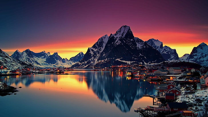 town structures and body of water, clear calm body of water in front ice covered mountains under orange and blue sky, Lofoten, Norway, mountains, cityscape, HD wallpaper