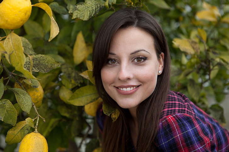 women's red and blue top, woman in red and blue plaid shirt near green plants during daytime, women, model, brunette, long hair, face, portrait, Lorena Garcia, brown eyes, smiling, women outdoors, shirt, checkered, trees, leaves, lemons, plaid shirt, looking at viewer, HD wallpaper