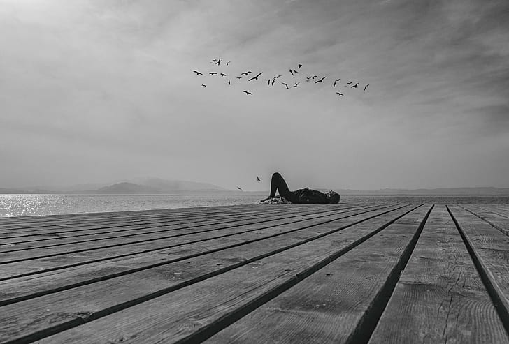 person lying on gray wooden surface, person, surface  street, bw, sea, nature, sky, animal, bird, sunset, HD wallpaper