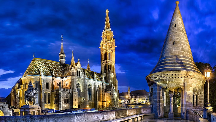 beige concrete gothic architectural building, cityscape, architecture, building, city, night, lights, Budapest, Hungary, cathedral, tower, ancient, history, statue, old building, town square, bricks, trees, clouds, evening, church, horse, king, HDR, HD wallpaper