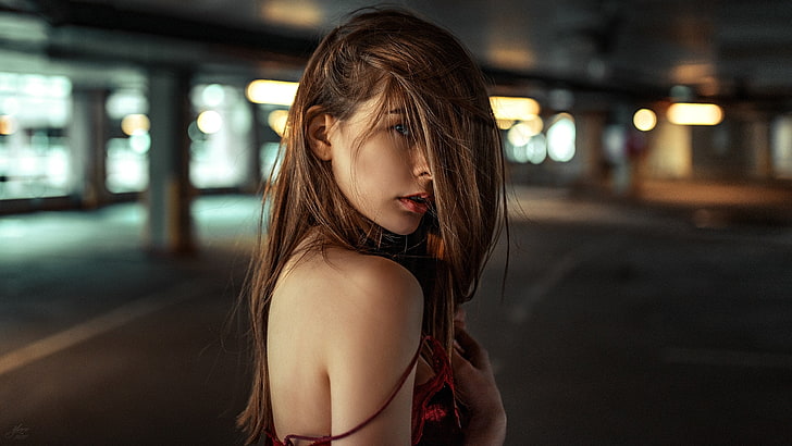 women's red and black top, shallow focus photography of woman in red spaghetti-strap dress during daytime, women, brunette, hair in face, blue eyes, bare shoulders, portrait, face, bokeh, parking lot, Yuriy Lyamin, parking, long hair, HD wallpaper