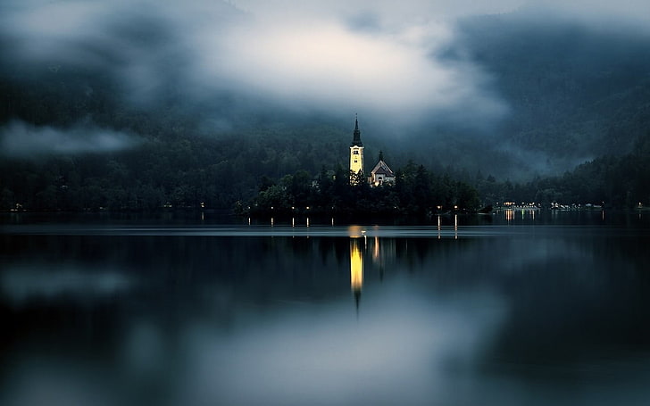 village near body of water, nature, landscape, mist, lake, mountains, forest, island, church, lights, Slovenia, Lake Bled, HD wallpaper