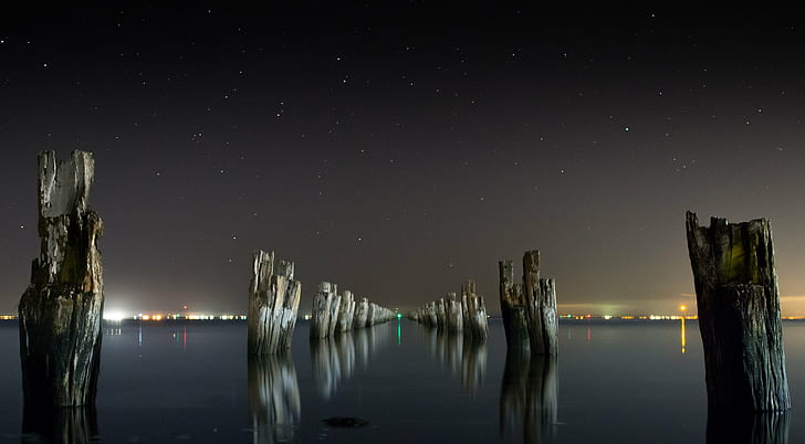 grey woods in the center of sea under black sky photography, jetty, center, sea, black sky, photography, night, dark  water, pier, stars, dusk, poles, pylons, seascape, landscape, ocean, reflection, nature, light, abstract, black  white, silhouette, tide, long  exposure, weather, space, clear, exploration, astronomy, science, solitude, quiet, galaxy, pylon, constellation, person, sky, HD wallpaper
