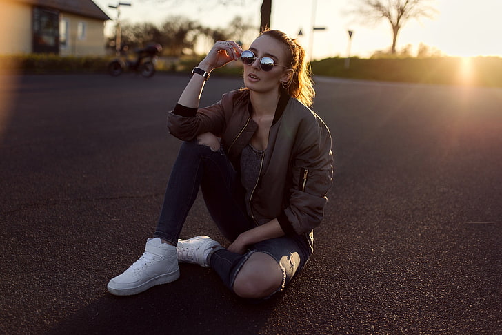 photo of woman wearing gray jacket and distress black-washed jeans, women, sitting, road, sneakers, sunglasses, sunset, jeans, torn jeans, portrait, jacket, women with glasses, HD wallpaper