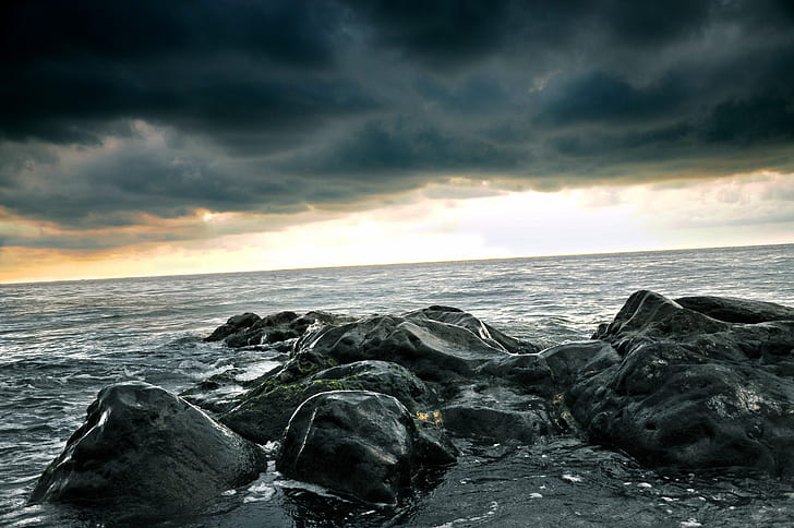 Stone formation in body of water under black cloudy sky during daytime, HD  wallpaper | Wallpaperbetter
