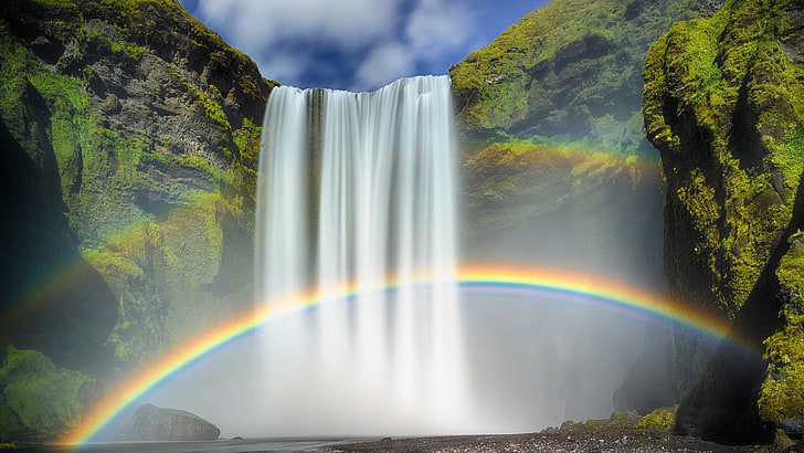 Skogafoss waterfalls, waterfalls between green trees, nature, waterfall, rainbows, moss, long exposure, Iceland, clouds, rock, water, stones, HD wallpaper